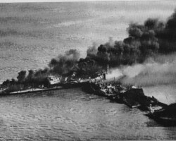 <em>Pan Massachusetts</em> can be seen burning furiously astern of the completely wrecked <em>Phoenix</em> on the morning of 6 June 1953. The two collided in the Delaware River the night before. <em>Phoenix</em> was empty, but exploded due to residual fumes in the empty tanks. She was a total loss. <em>Pan Massachusetts</em> was towed to the company yard in Kure, Japan and rebuilt into a larger tanker and renamed <em>Commonwealth</em>.